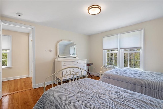 bedroom featuring baseboards and wood finished floors