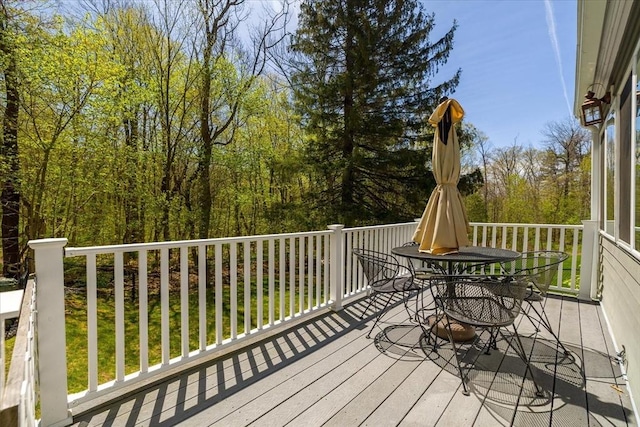wooden terrace with outdoor dining space