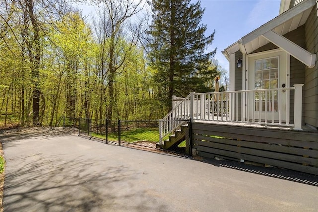 view of patio featuring fence and stairway