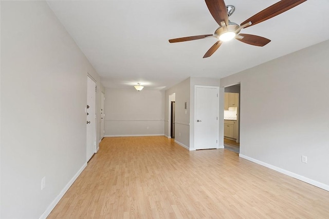 spare room featuring ceiling fan and light hardwood / wood-style flooring