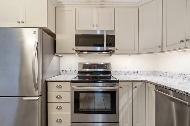 kitchen featuring light stone countertops and appliances with stainless steel finishes