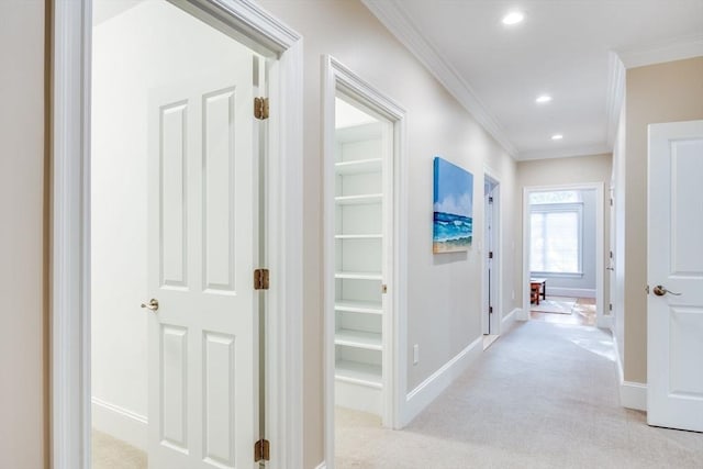 hallway with light colored carpet and ornamental molding