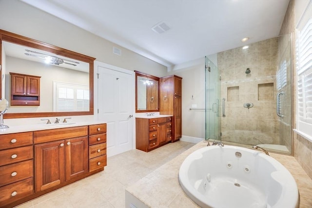 bathroom with tile patterned floors, vanity, and shower with separate bathtub