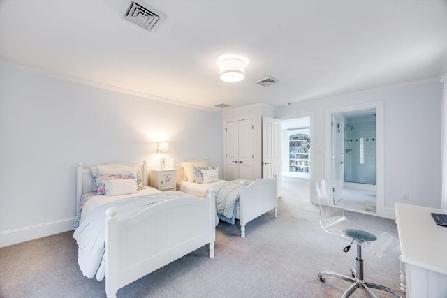 carpeted bedroom with connected bathroom, a closet, and crown molding