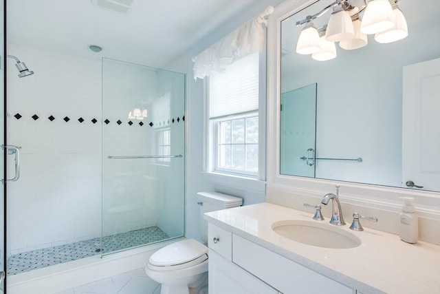 bathroom featuring tile patterned flooring, vanity, an enclosed shower, and toilet