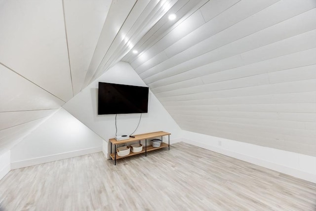 bonus room with vaulted ceiling and hardwood / wood-style flooring