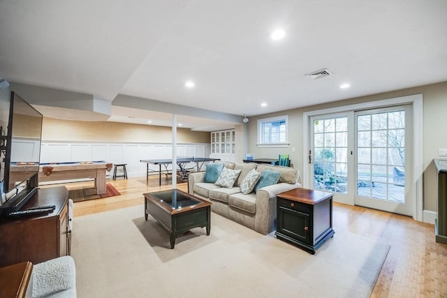 living room featuring light wood-type flooring and billiards