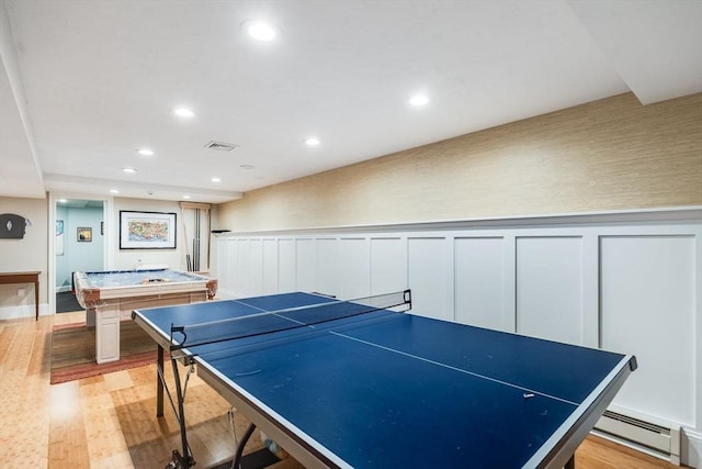 rec room featuring a baseboard radiator, light wood-type flooring, and billiards