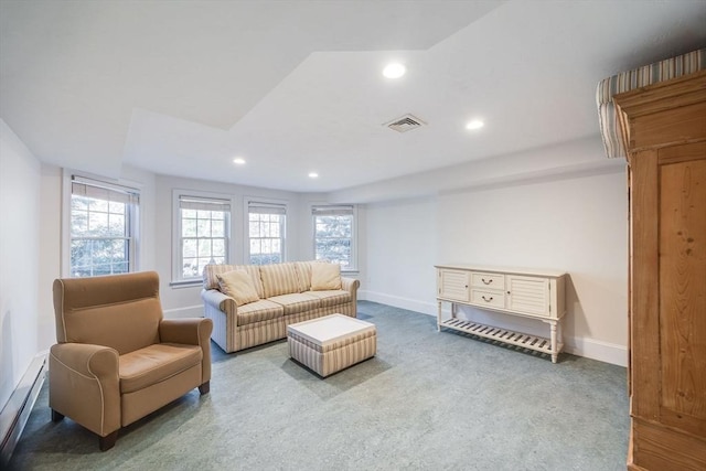 carpeted living room with a baseboard radiator