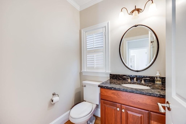 bathroom featuring vanity, toilet, and ornamental molding