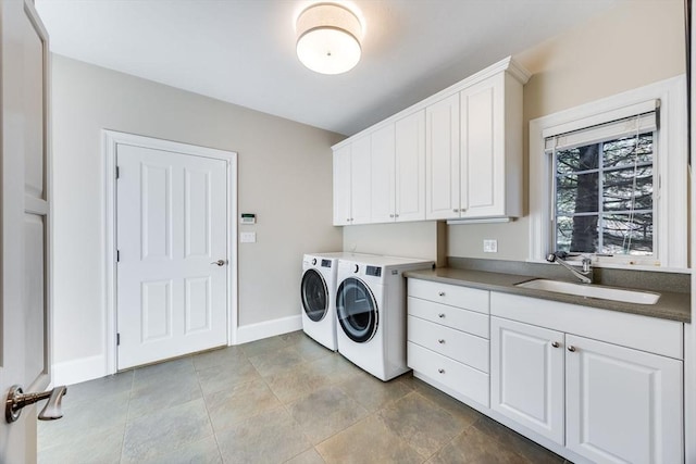 laundry area featuring sink, cabinets, and independent washer and dryer