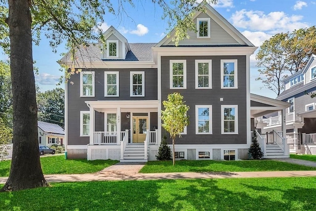 view of front of home with a porch and a front lawn