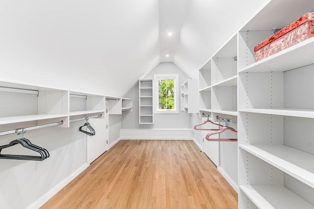 spacious closet featuring vaulted ceiling and light hardwood / wood-style floors