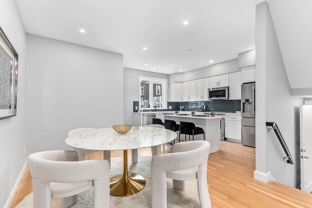 dining space featuring light hardwood / wood-style floors