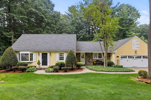 10 Granada Way, Andover, MA 01810 - view of front facade featuring board and batten siding, a shingled roof, concrete driveway, and a front yard