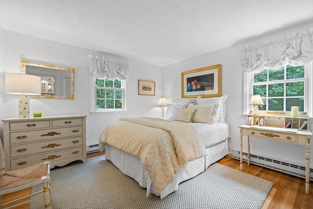 10 Granada Way, Andover, MA 01810 - bedroom with a baseboard radiator and wood finished floors