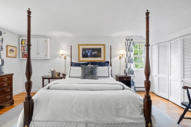 10 Granada Way, Andover, MA 01810 - bedroom with baseboard heating, light wood-style floors, a closet, and baseboards