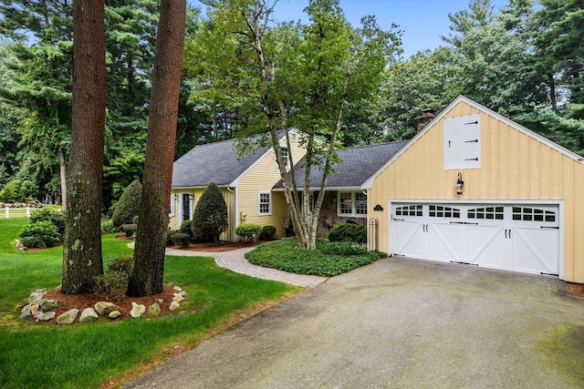 10 Granada Way, Andover, MA 01810 - view of front of house featuring a chimney, asphalt driveway, a front lawn, a garage, and a shingled roof