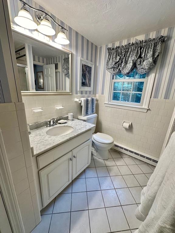 10 Granada Way, Andover, MA 01810 - bathroom featuring a baseboard heating unit, tile patterned floors, tile walls, vanity, and a shower stall