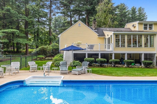 10 Granada Way, Andover, MA 01810 - back of house featuring a patio area, a chimney, view of wooded area, a sunroom, and a balcony
