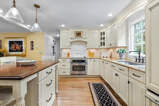 10 Granada Way, Andover, MA 01810 - kitchen with oven, a sink, wood counters, hanging light fixtures, and light wood finished floors
