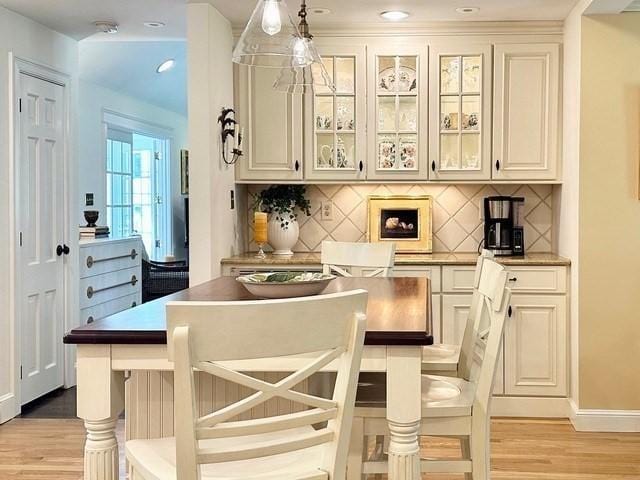 10 Granada Way, Andover, MA 01810 - bar area featuring light wood finished floors, decorative backsplash, baseboards, and pendant lighting