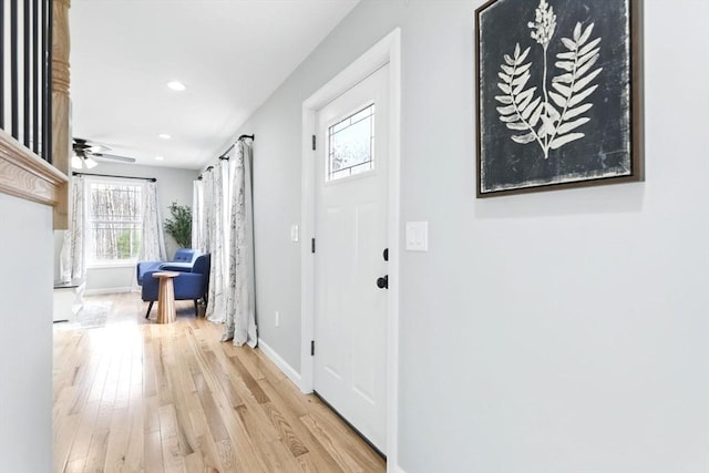 hallway featuring baseboards, recessed lighting, and wood finished floors