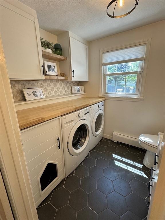 12 Bonin Dr, Haverhill, MA 01832 - laundry area with washing machine and dryer, a baseboard radiator, a textured ceiling, and dark tile patterned flooring