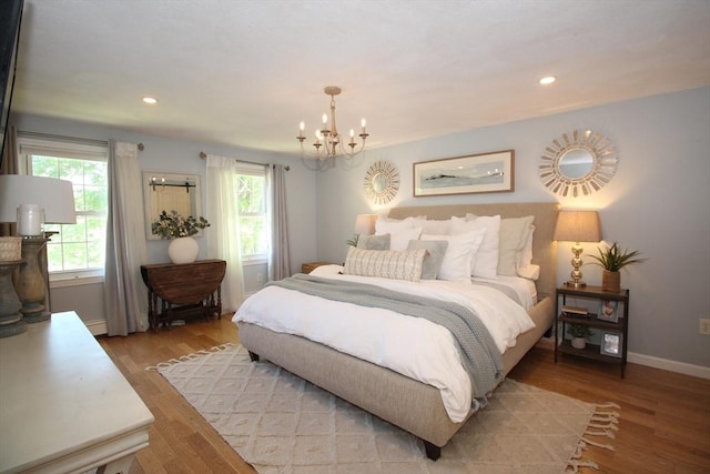 12 Bonin Dr, Haverhill, MA 01832 - bedroom with a chandelier, baseboards, light wood-style flooring, recessed lighting, and a baseboard radiator