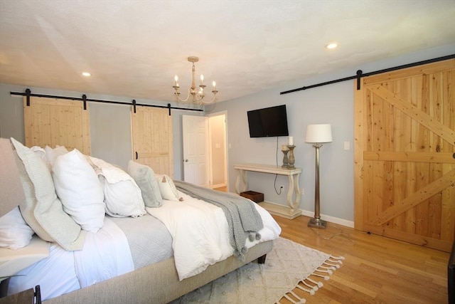 12 Bonin Dr, Haverhill, MA 01832 - bedroom featuring a barn door, light wood-type flooring, a chandelier, baseboards, and recessed lighting