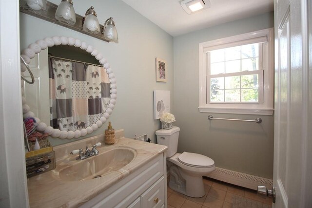 12 Bonin Dr, Haverhill, MA 01832 - full bath with a baseboard radiator, vanity, toilet, tile patterned flooring, and a shower with shower curtain
