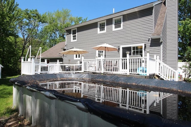 12 Bonin Dr, Haverhill, MA 01832 - back of property featuring a wooden deck and a chimney