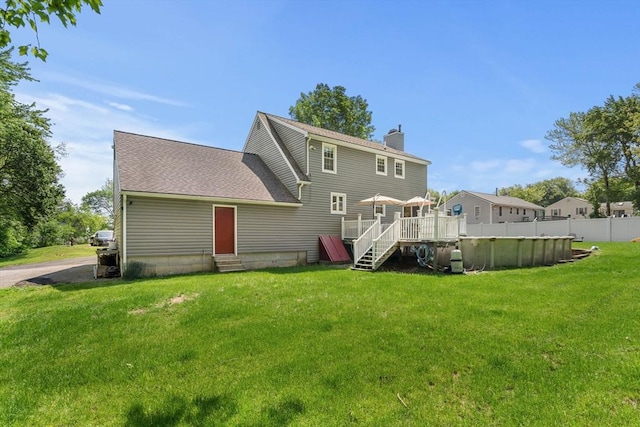 12 Bonin Dr, Haverhill, MA 01832 - back of house with entry steps, a chimney, and a wooden deck