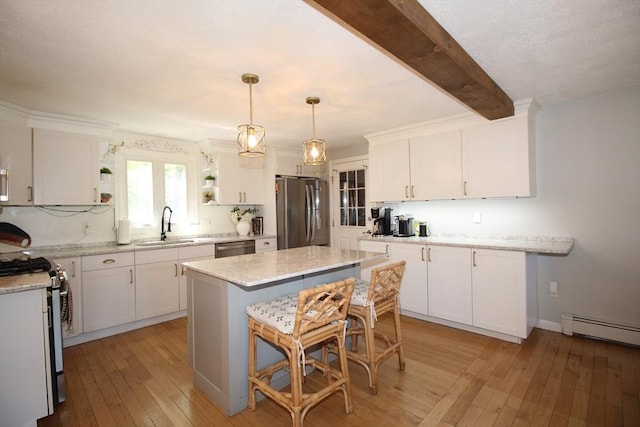 12 Bonin Dr, Haverhill, MA 01832 - kitchen with appliances with stainless steel finishes, open shelves, light wood-style floors, white cabinetry, and a sink