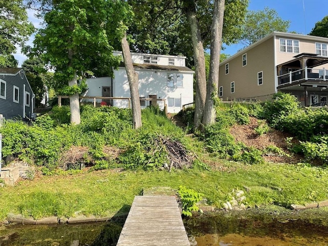 rear view of house featuring a water view