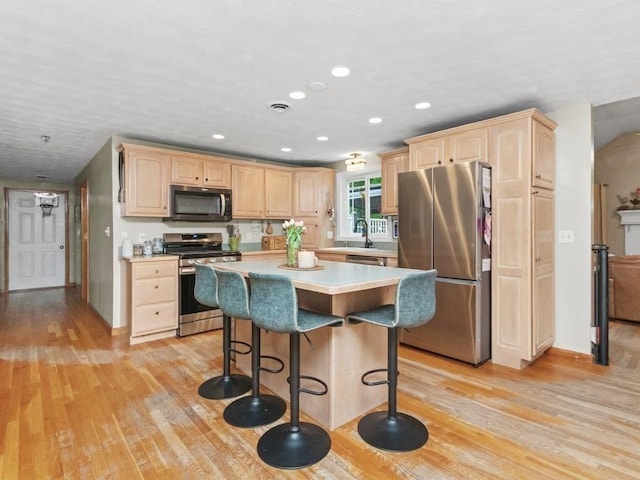 48 Twin Brook Ln, Taunton, MA 02780 - kitchen featuring stainless steel appliances, light brown cabinetry, light wood-type flooring, a breakfast bar, and recessed lighting
