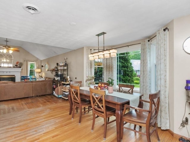 48 Twin Brook Ln, Taunton, MA 02780 - dining area with light wood-style flooring, a fireplace, a ceiling fan, and lofted ceiling