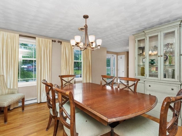 48 Twin Brook Ln, Taunton, MA 02780 - dining space with a chandelier, light wood finished floors, baseboard heating, and a textured ceiling