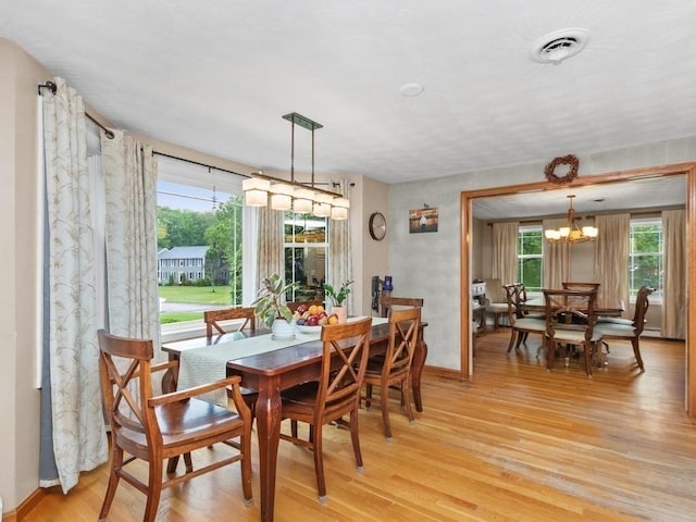 48 Twin Brook Ln, Taunton, MA 02780 - dining space with light wood finished floors, healthy amount of natural light, a chandelier, and baseboards