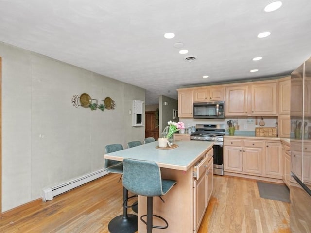 48 Twin Brook Ln, Taunton, MA 02780 - kitchen with appliances with stainless steel finishes, light brown cabinets, a baseboard radiator, a breakfast bar area, and recessed lighting