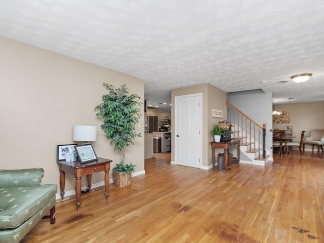 48 Twin Brook Ln, Taunton, MA 02780 - sitting room with stairway, light wood-type flooring, baseboards, and a chandelier
