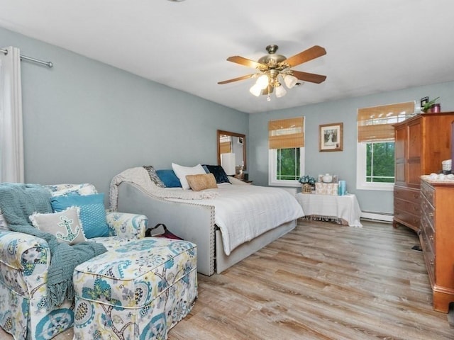 48 Twin Brook Ln, Taunton, MA 02780 - bedroom with a baseboard heating unit, light wood-style floors, and a ceiling fan