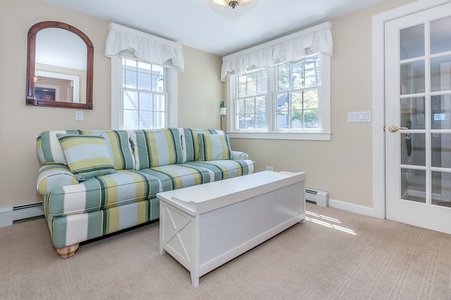 living room with light carpet, a baseboard radiator, and a wealth of natural light