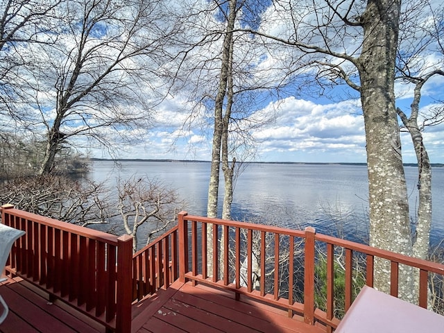 wooden terrace featuring a water view