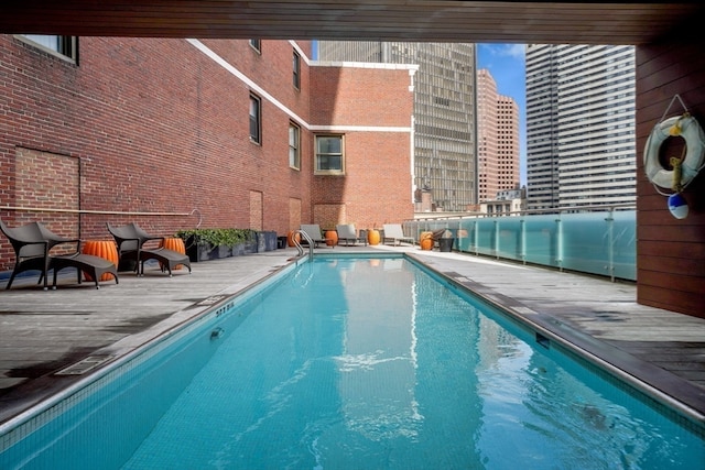 view of swimming pool with a wooden deck