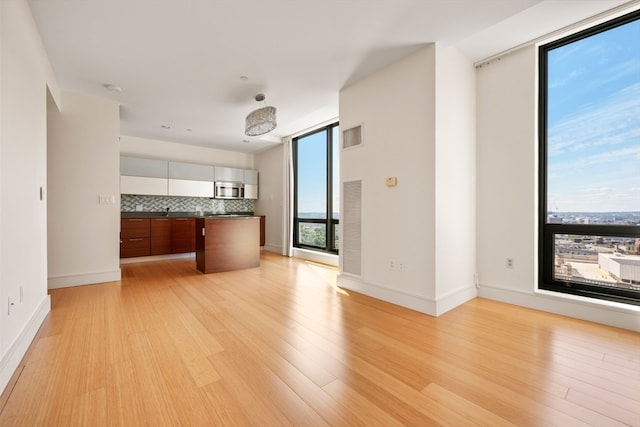 unfurnished living room with light hardwood / wood-style floors