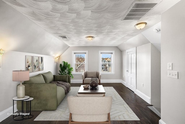 living room featuring lofted ceiling and dark hardwood / wood-style floors