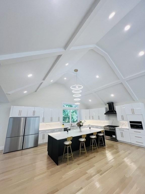 1 Harvard Ave, Burlington, MA 01803 - kitchen featuring stainless steel appliances, wall chimney exhaust hood, a breakfast bar, white cabinetry, and beam ceiling