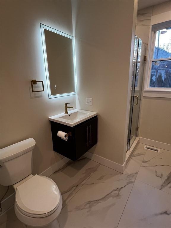 1 Harvard Ave, Burlington, MA 01803 - full bathroom with vanity, a shower stall, and marble look tile flooring