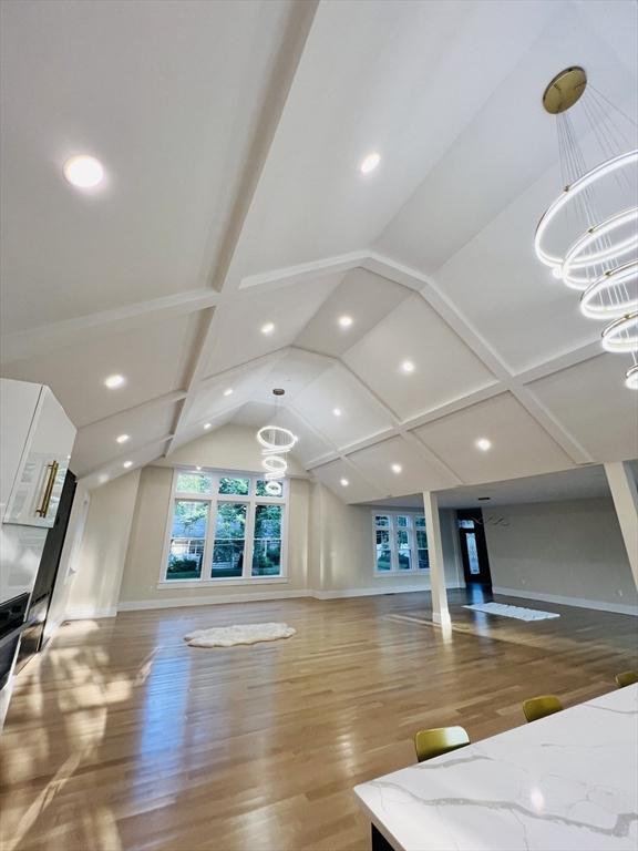 1 Harvard Ave, Burlington, MA 01803 - unfurnished living room with a chandelier, vaulted ceiling, wood finished floors, and recessed lighting